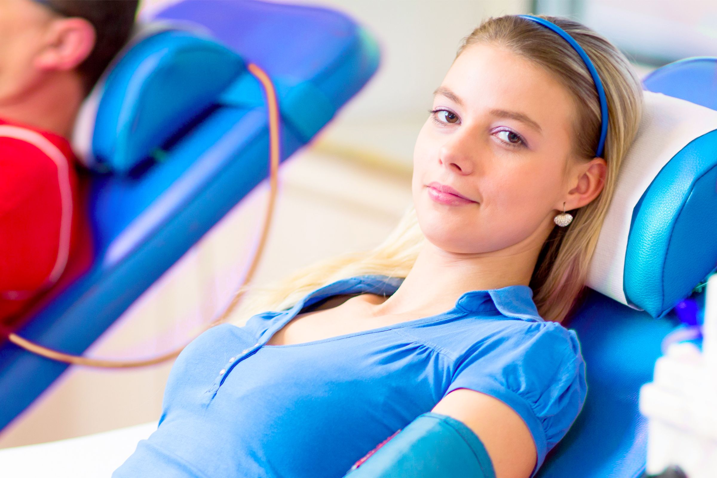 a woman lying in a chair donating blasma